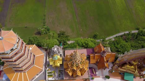 Aerial-Drone-backing-out-reveal-of-Wat-Tham-Sua-Temple,-Kanchanaburi,-Thailand