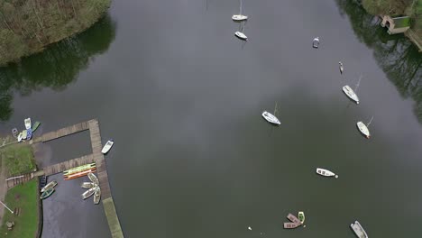 Beautiful-aerial-view,-footage-by-Rudyard-Lake-in-the-Derbyshire-Peak-District-National-Park,-popular-holiday,-tourist-attraction-with-boat-rides-and-water-sports-on-off,-peaceful,-calm-water