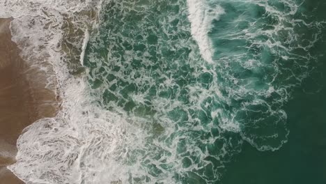 Afternoon-camera-down-drone-view-from-the-water-and-deeply-waves-of-Redondo-Beach,-California