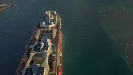 Aerial-sideways-fly-over-view-of-a-big-cruise-ship-close-to-the-coast