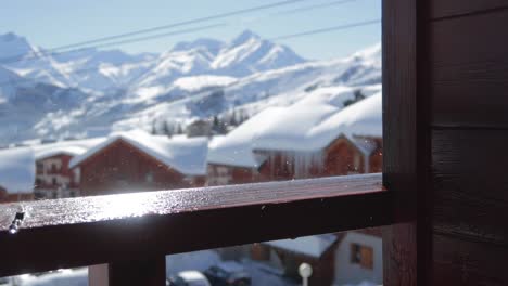 Water-droplets-falling-onto-wooden-balcony-ramp-in-a-ski-resort-in-winter
