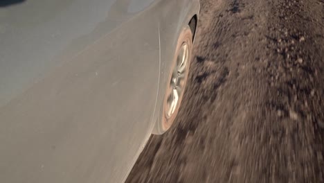 Car-wheel-riding-along-a-desert-sand-road