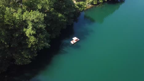 view-of-a-small-boat-at-Monticchio's-lakes-from-a-drone