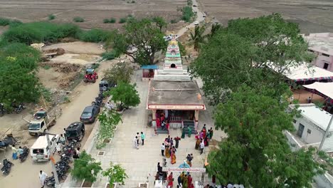 Aerial-view-of-the-busy-crowd-entering-into-the-temple-and-wedding-ceremony-tent-or-building-in-vehicles