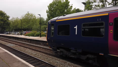 First-Great-Western-Train-Departing-Bradford-on-Avon-Station-in-Wiltshire-Revealing-Old-Fashioned-Signage-on-Other-Platform-in-Slow-Motion