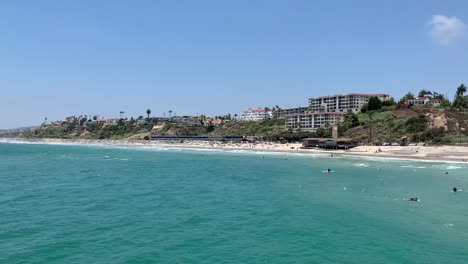 A-Pacific-Surfliner-train-passing-through-the-beautiful-coastlines-of-San-Clemente-beach-pier-in-Southern-California