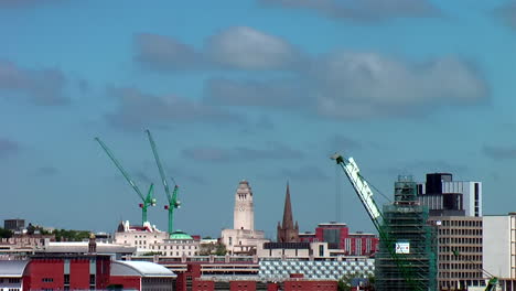 Time-Lapse-of-Leeds-City-Centre-Skyline-including-Parkinson-Building,-Leeds-Town-Hall---Cranes-during-Summer’s-Day-with-Blue-Sky---White-Clouds