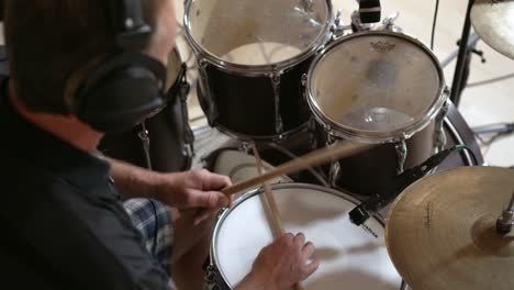 Drummer-playing-hi-hat-and-snare-rim,-low-angle-closeup