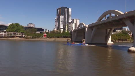 Small-barge-conveys-Loader-and-crew-along-Brisbane-River