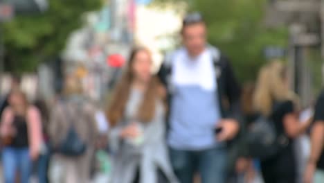Slow-motion-of-defocused-commuters-walking-to-work-or-shopping,-footage-of-blurred-unrecognizable-people,-busy-city-life