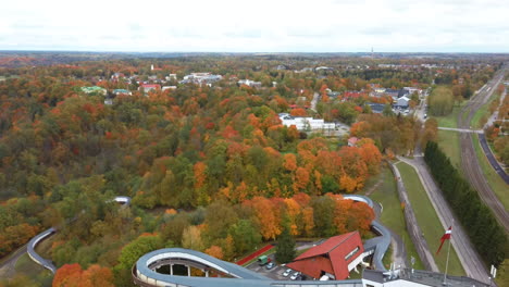 Autumn-Landscape-Aerial-View-of-the-Bobsleigh-and-Skeleton-Track-Luge-Track-Sigulda-Surrounded-by-Colorful-Forests-During-Golden-Autumn-Season-in-Latvia