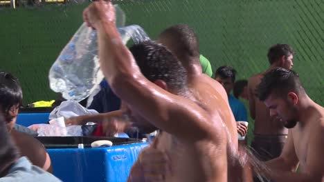 close-up,-lateral-shot,-man-taking-a-shower-on-a-public-space-of-a-shelter-in-Mexico-city