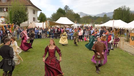 Happy-Medieval-costumed-dancers-at-swiss-medieval-event,steady-wide-shot