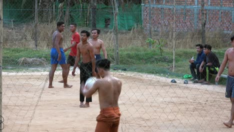 Exterior-Medium-Static-Shot-of-a-Group-of-Men-Playing-Volleyball-in-Daytime