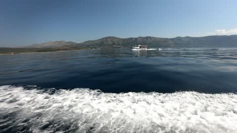 Small-tourist-taxi-boat-is-passing-another-boat-in-the-waters-of-Dubrovnik-riviera,-Adriatic,-Croatia