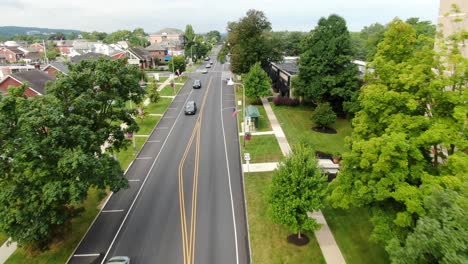 Hersheys-Kisses-top-streetlights-on-brick-lined-road,-aerial-view