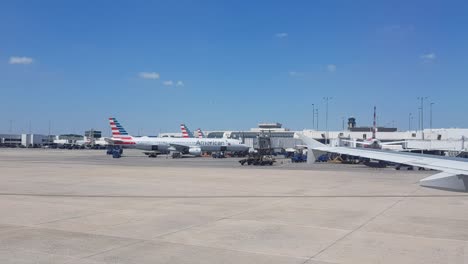 Riding-on-airplane-to-Dallas-Airport-gate,-wing-is-visible