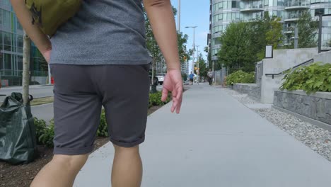 Close-up-to-the-foot-of-a-man-while-walking-on-the-path-way-in-Vancouver-City,Canada-in-summer-sunshine-daytime