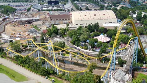 Skyrush-at-Hershey-Park-Amusement-Park---Slow-aerial-turn-as-theme-park-riders-enjoy-roller-coaster,-drone-view