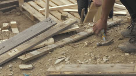 Refugee-removes-nails-from-pallet-wood-Moria-Refugee-Camp