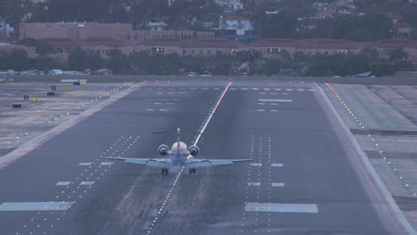 A-small-regional-jet-lands-at-San-Diego-International-Airport-after-an-evening-rain-storm