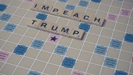Closeup-shot-Impeach-Trump-spelled-out-in-Scrabble-letters-on-Scrabble-game-board