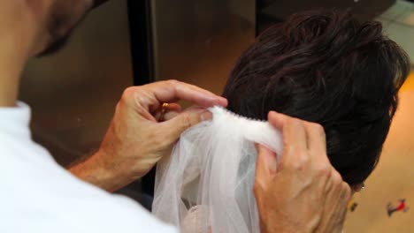 Makeup-artist-putting-veil-on-bride,-final-details-before-going-to-church-and-getting-married,-beautiful,-wonderful,-lush