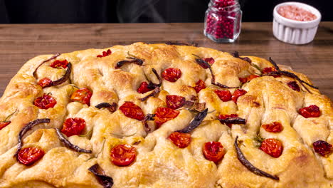 Traditional-Italian-Focaccia-with-cherry-tomatoes,-black-olives-and-rosemary