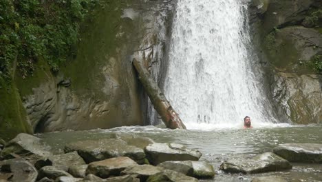 Young-Bearded-Man-Enjoying-Refreshing-Cool-Natural-Pool-of-Pruncea-Waterfall,-Slow-Motion
