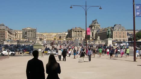 People-walking-outside-of-the-Versailles-Palace,-Paris,-France