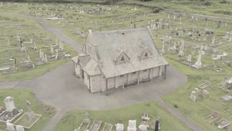 Llandudno-coastal-Tudnos-church-mountain-chapel-graveyard-aerial-view-orbit-left