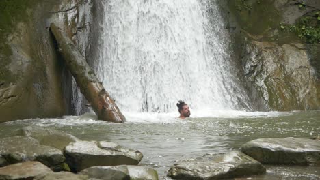 Slow-Motion-Scene,-Bearded-Man-Swimming-in-Cold-Waters-of-Pruncea-Waterfall,-Romania