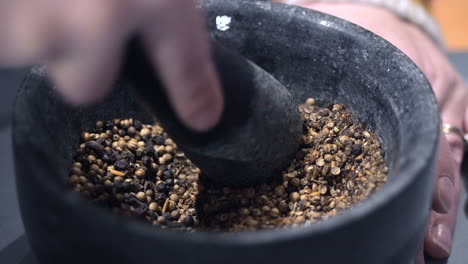 Spices-Being-Crushed-With-A-Mortar-And-Pestle,-CLOSE-UP