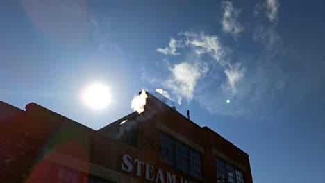 Steam-coming-out-of-the-chimney-on-a-clear-day-at-Steam-whistle-brewing-building