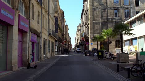 Rue-Saint-Rémi-normally-busy-commercial-street-empty-due-to-the-COVID-19-pandemic,-Stable-handheld-walking-shot