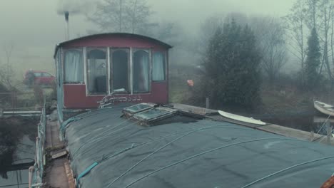 Houseboat-barge-wheelhouse-cabin-on-river-atmospheric-fog