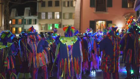 Colorful-illuminated-people-dancing-outdoor-on-marketplace-during-carnival-festival-till-midnight