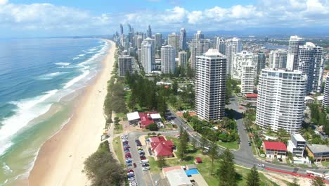 Rising-and-Looking-south-along-Surfers-Paradise-skyline,-iconic-surf-beaches,-clear-summers-day