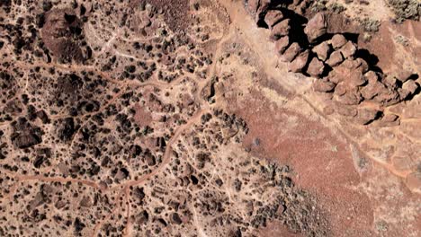 Looking-down-on-Frenchman's-Coulee,-basalt-columns-create-a-natural-wall,-aerial