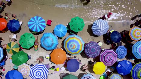 Aerial-top-down-shot-of-umbrellas-occuping-all-the-beach-withouth-space-between-each-other
