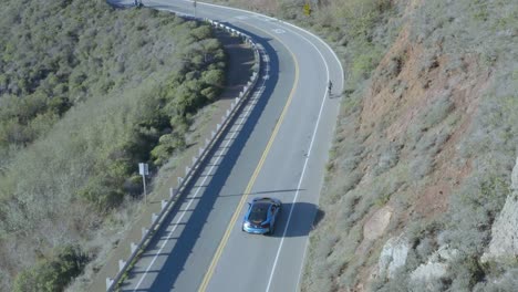 Aerial-view-BMW-i8-sports-car-driving-mountain-hill-country-road