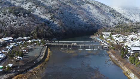 Arashiyama-in-Winter-Scene-and-Togetsukyo-Bridge,-Aerial-Pullback-Tilt-Shot