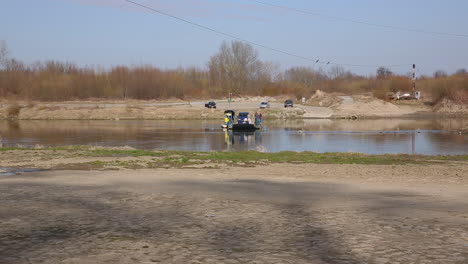 Ferry-river-crossing,-old-boat-carrying-cars-and-people
