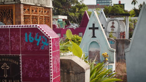Gimbal-shot-of-cramped-graves-in-Christian-and-catholic-cemetery,-Medan