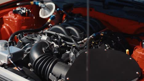 Arc-Shot-of-Muscle-Car-V8-Engine-of-a-Red-Ford-Mustang-GT3