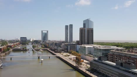 Downtown-Buenos-Aires-Argentine-modern-urban-waterfront-river-bridge-skyscraper-cityscape-aerial-left-pan