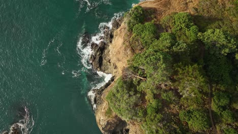 Overhead-drone-shot-of-a-steep-cliff-overlooking-the-Pacific-Ocean