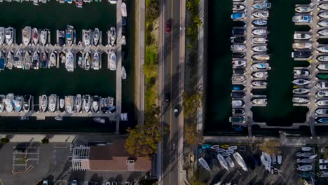 Top-down-aerial-of-road-way-separating-two-full-boat-docking-areas