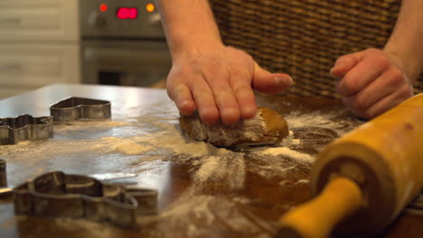 Flattening-gingerbread-dough-with-hands-on-a-floured-table