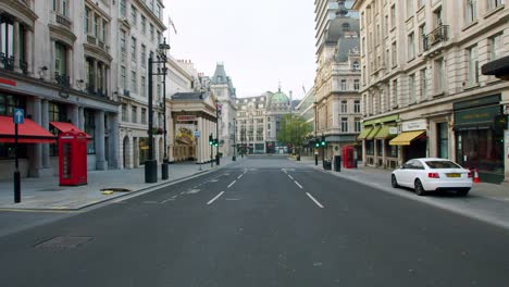 Lockdown-in-London,-empty-Haymarket-Street,-West-End,-with-closed-shops-and-restaurants,-during-the-Coronavirus-pandemic-2020